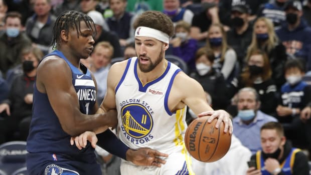 Jan 16, 2022; Minneapolis, Minnesota, USA; Golden State Warriors k11 Klay Thompson (11) dribbles around Minnesota Timberwolves forward Anthony Edwards (1) in the first quarter at Target Center. Mandatory Credit: Bruce Kluckhohn-USA TODAY Sports